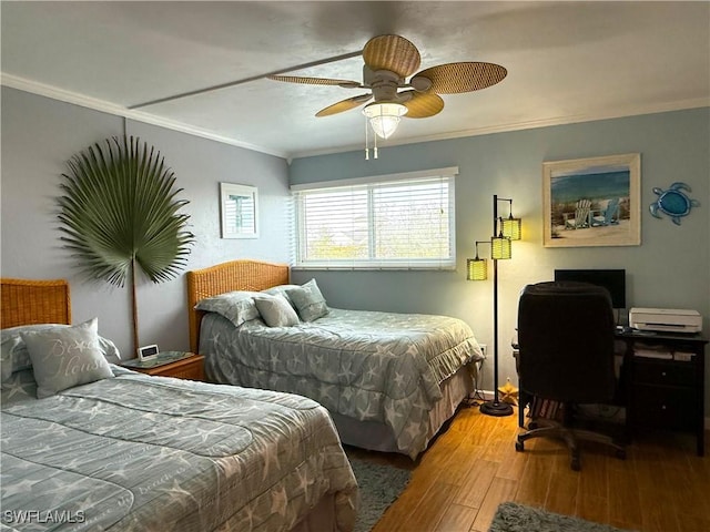 bedroom with hardwood / wood-style flooring, ornamental molding, and ceiling fan