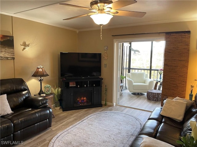 living room with ornamental molding, light hardwood / wood-style flooring, and ceiling fan