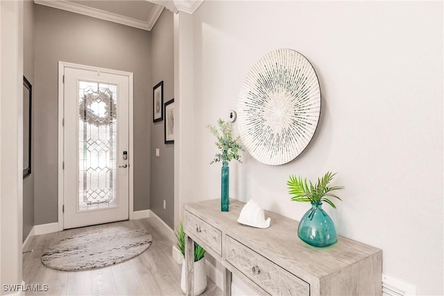 entrance foyer with crown molding and wood-type flooring