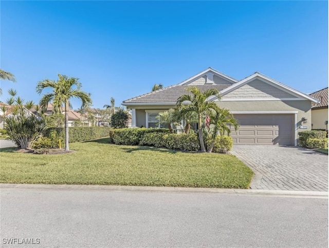 view of front of property featuring a garage and a front yard