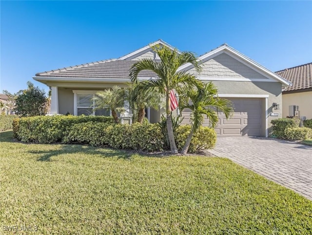 view of front of property featuring a garage and a front yard