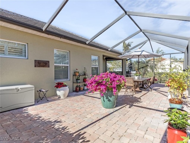 view of patio with glass enclosure