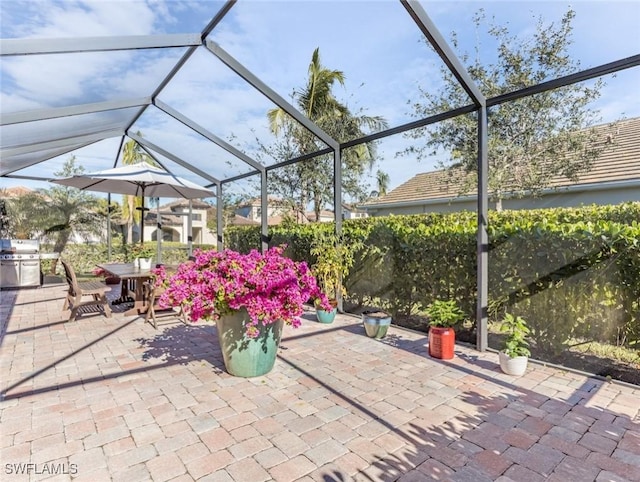 view of patio / terrace with area for grilling and glass enclosure