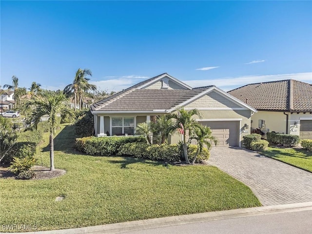 single story home featuring a garage and a front yard