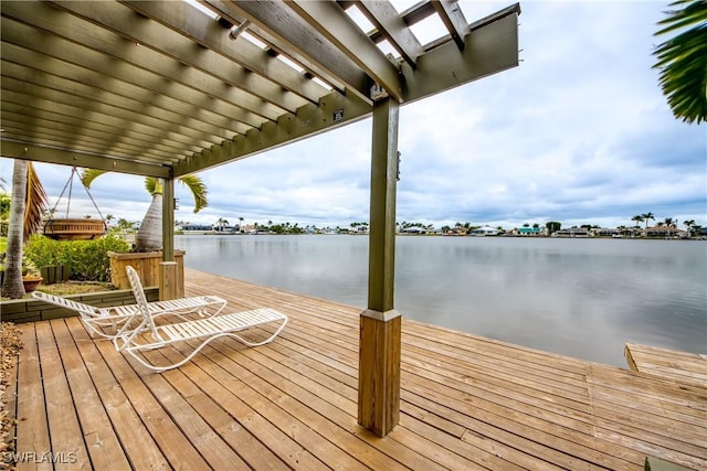 dock area with a water view and a pergola