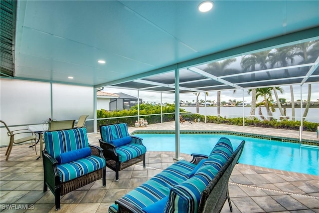 outdoor pool with glass enclosure, a patio, and outdoor lounge area