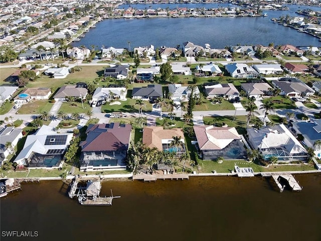 birds eye view of property with a residential view and a water view