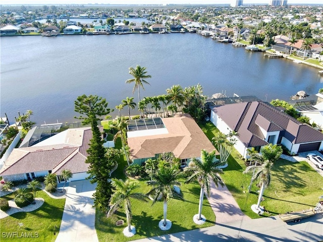 birds eye view of property with a water view and a residential view