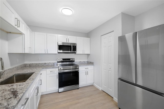 kitchen with white cabinetry, sink, and appliances with stainless steel finishes