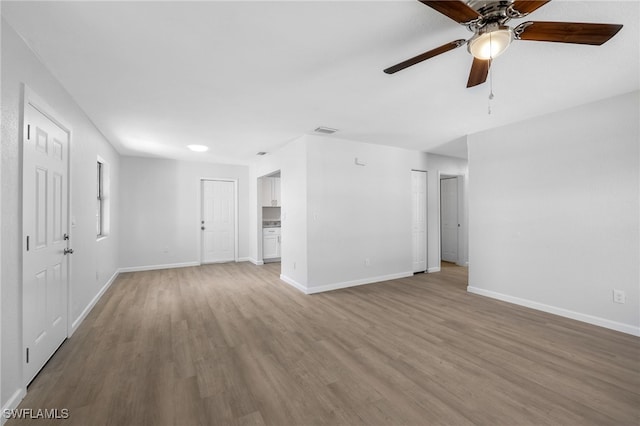 empty room featuring ceiling fan and light hardwood / wood-style floors