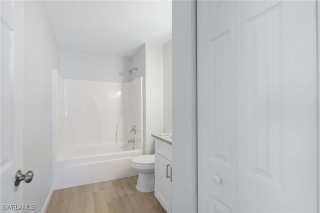 full bathroom featuring shower / tub combination, vanity, wood-type flooring, and toilet