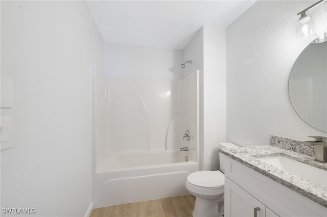 full bathroom with vanity, hardwood / wood-style flooring, bathing tub / shower combination, and toilet