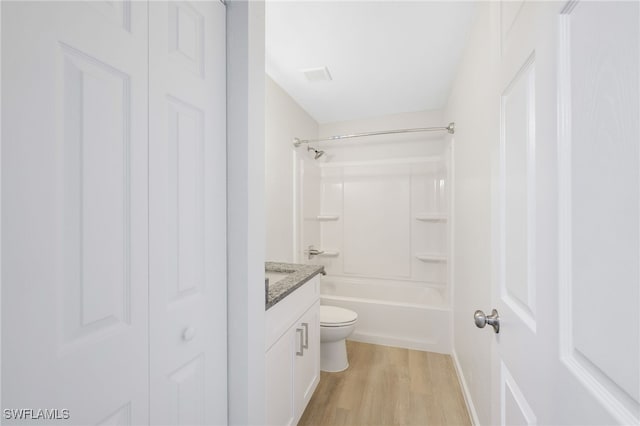 full bathroom featuring vanity, wood-type flooring, shower / tub combination, and toilet