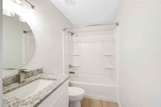 full bathroom featuring vanity, hardwood / wood-style flooring, shower / tub combination, and toilet