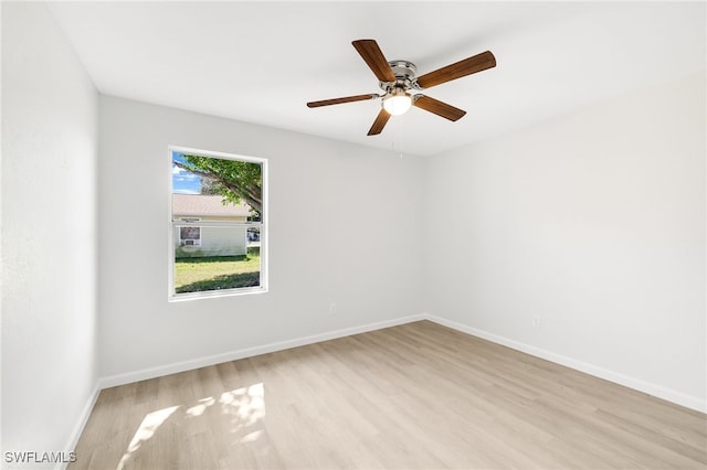 empty room with ceiling fan and light wood-type flooring