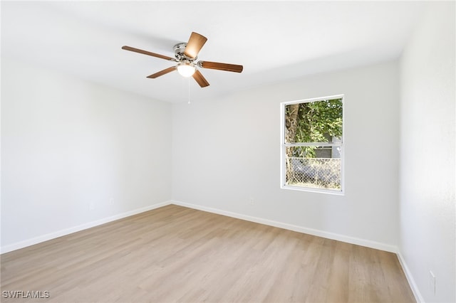 unfurnished room with ceiling fan and light wood-type flooring