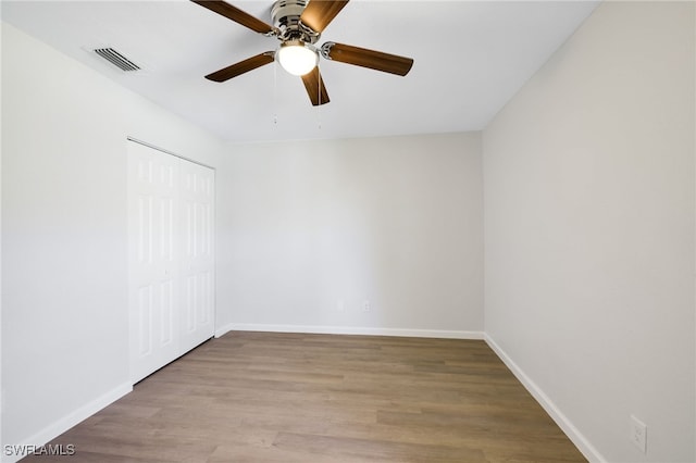 empty room featuring ceiling fan and light hardwood / wood-style floors