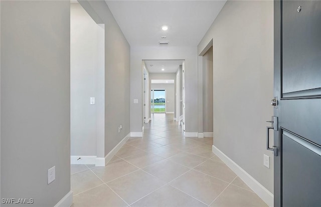 hall featuring light tile patterned floors