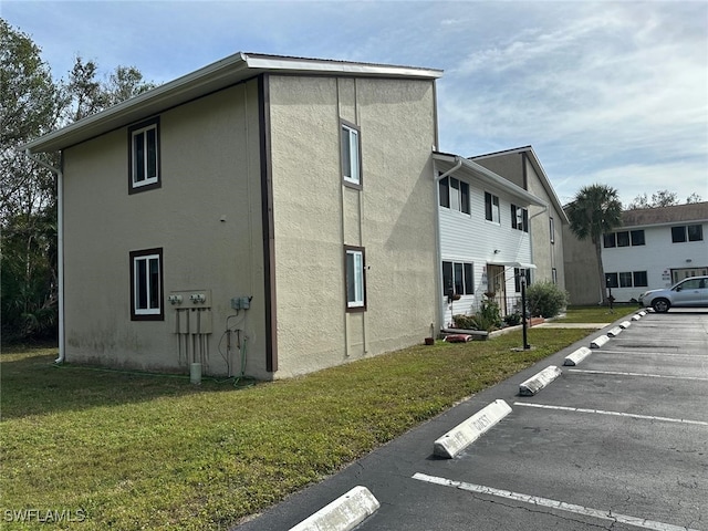 view of property exterior with a yard