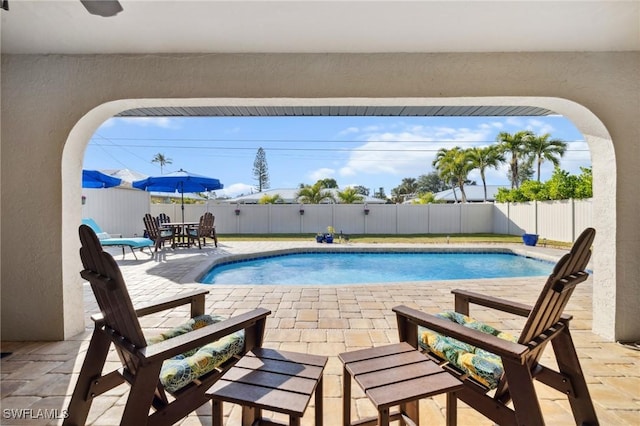 view of swimming pool featuring a patio area, a fenced backyard, and a fenced in pool