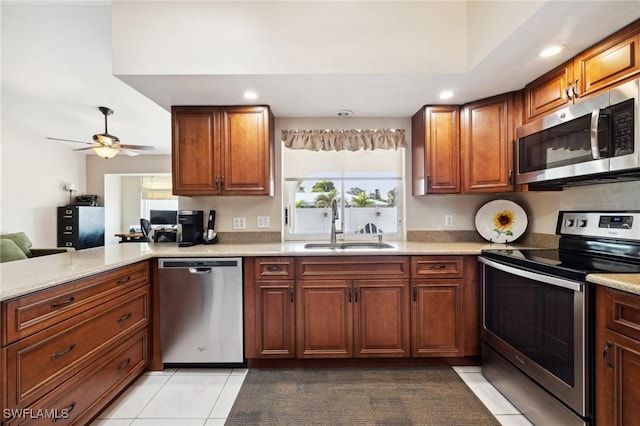 kitchen with sink, light tile patterned floors, kitchen peninsula, ceiling fan, and stainless steel appliances