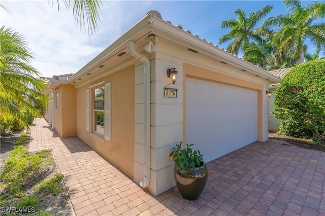 view of side of home with a garage