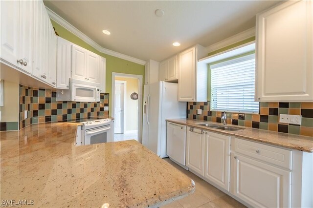 kitchen featuring light stone counters, white appliances, sink, and white cabinets