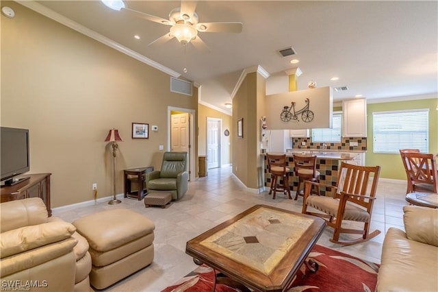 living room featuring light tile patterned floors, crown molding, and ceiling fan