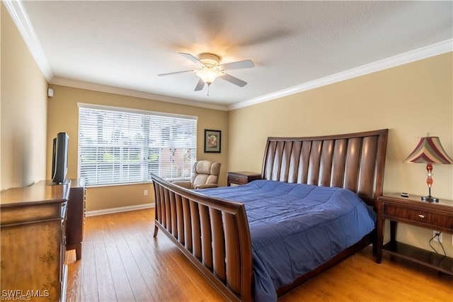 bedroom featuring crown molding, ceiling fan, and light wood-type flooring