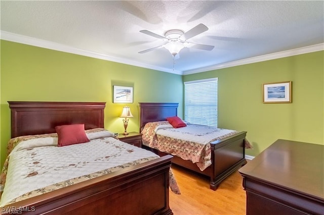 bedroom featuring crown molding, ceiling fan, light hardwood / wood-style floors, and a textured ceiling