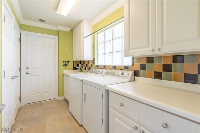 washroom featuring sink, cabinets, ornamental molding, washer and dryer, and light tile patterned flooring