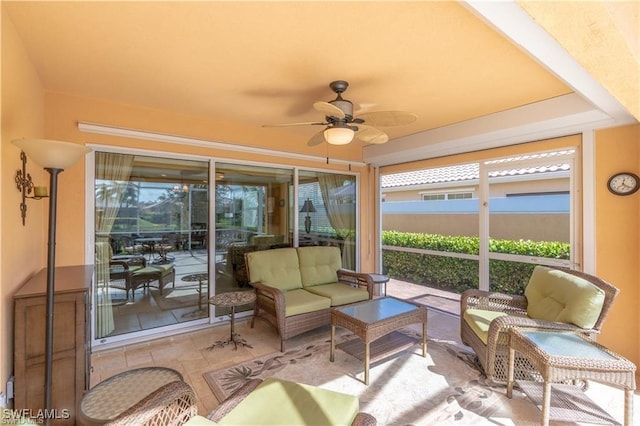 sunroom featuring ceiling fan