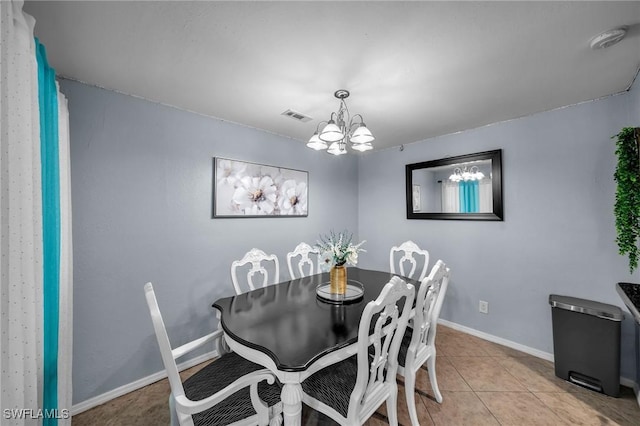 dining room featuring a notable chandelier and light tile patterned floors