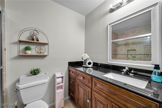 bathroom with toilet, vanity, and walk in shower