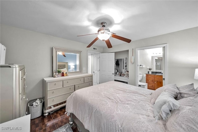 bedroom with ceiling fan, ensuite bath, and dark hardwood / wood-style floors