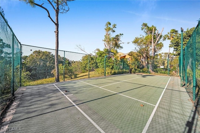 view of tennis court featuring basketball hoop