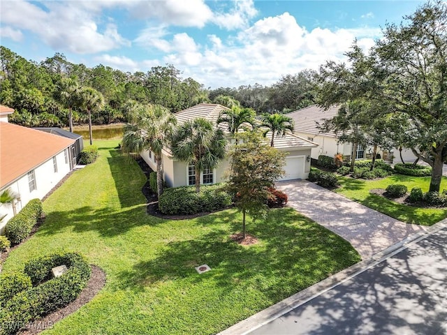 view of front of house with a garage and a front yard