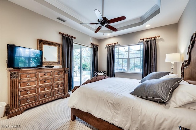 bedroom with ceiling fan, a tray ceiling, ornamental molding, light carpet, and access to outside