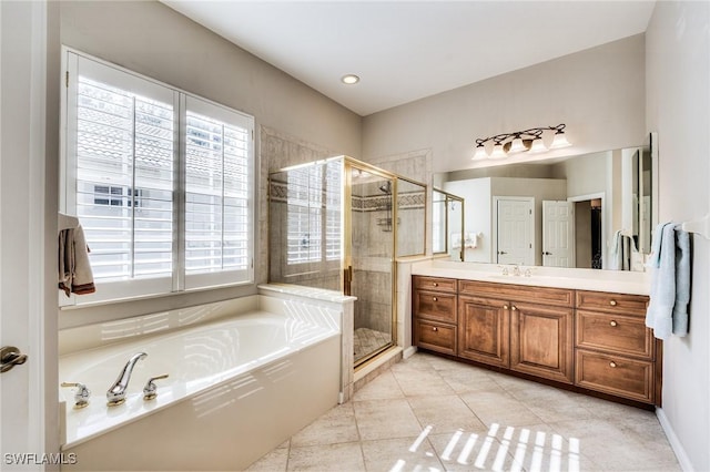 bathroom featuring tile patterned flooring, vanity, and separate shower and tub