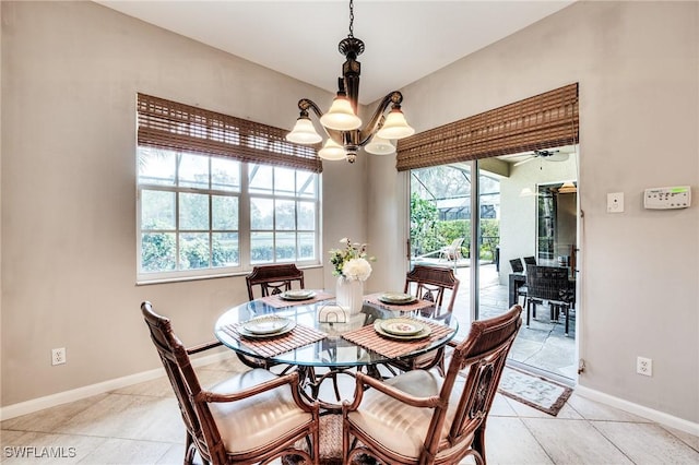 dining room with light tile patterned floors and a chandelier