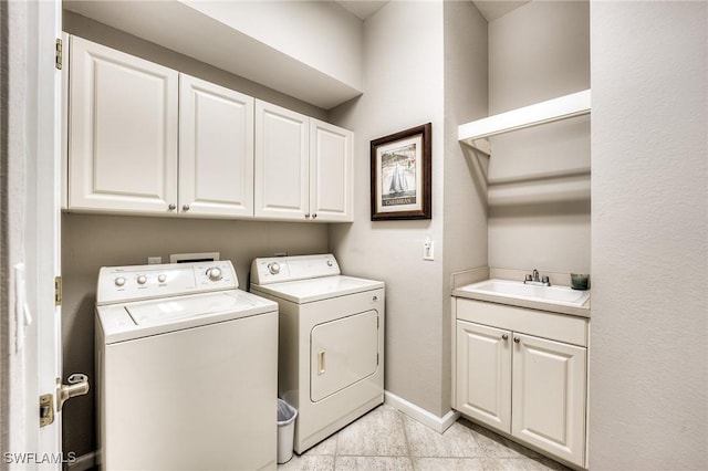 laundry room featuring cabinets, sink, and independent washer and dryer