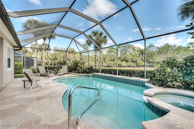 view of swimming pool featuring an in ground hot tub, a lanai, and a patio area