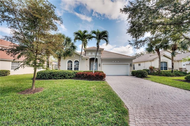 view of front of house featuring a garage and a front yard