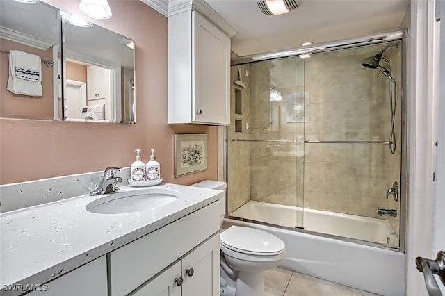 full bathroom featuring shower / bath combination with glass door, visible vents, toilet, vanity, and tile patterned floors