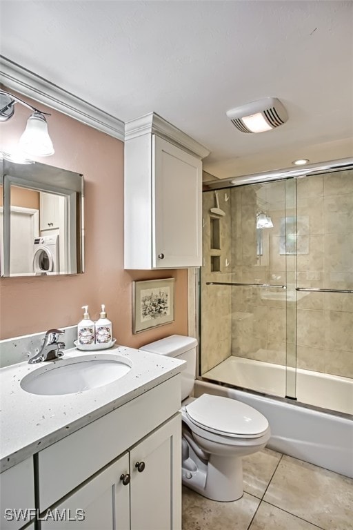 bathroom with washer / dryer, visible vents, toilet, tile patterned floors, and vanity