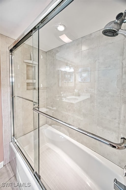 full bathroom featuring shower / bath combination with glass door