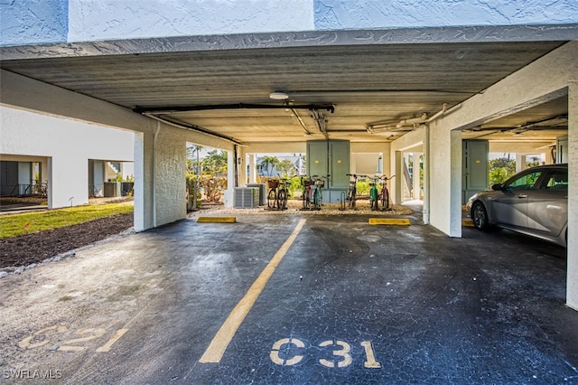 view of car parking featuring electric panel and a parking garage