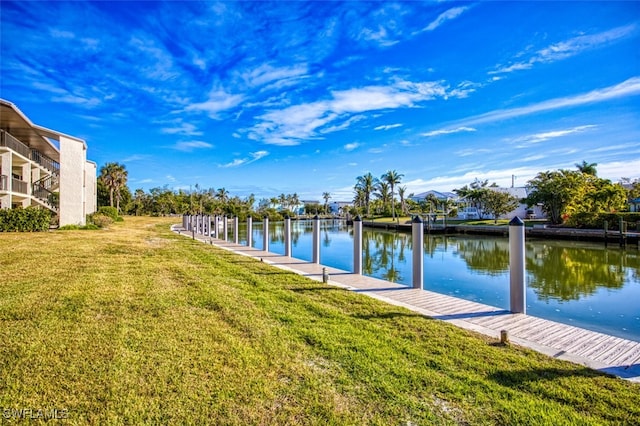 dock area featuring a water view and a lawn