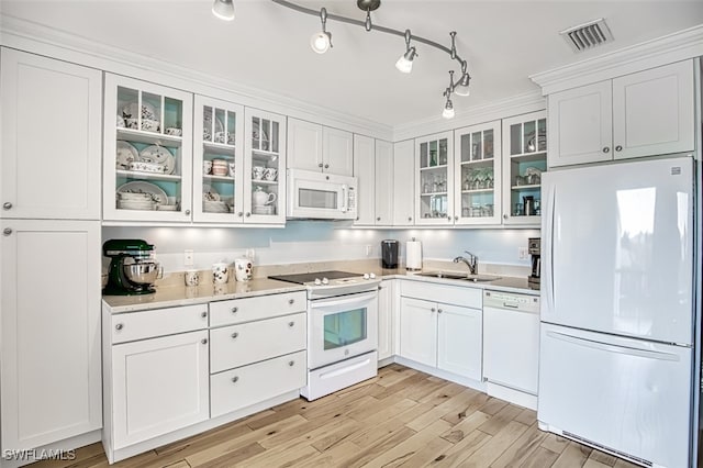 kitchen featuring visible vents, light wood-style flooring, white cabinetry, a sink, and white appliances