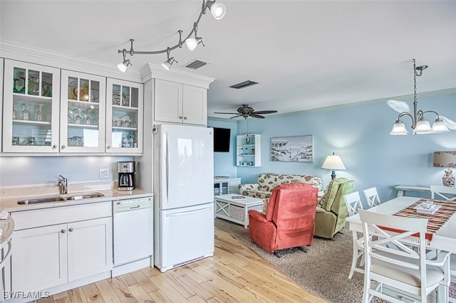 kitchen with white appliances, visible vents, light countertops, white cabinetry, and a sink